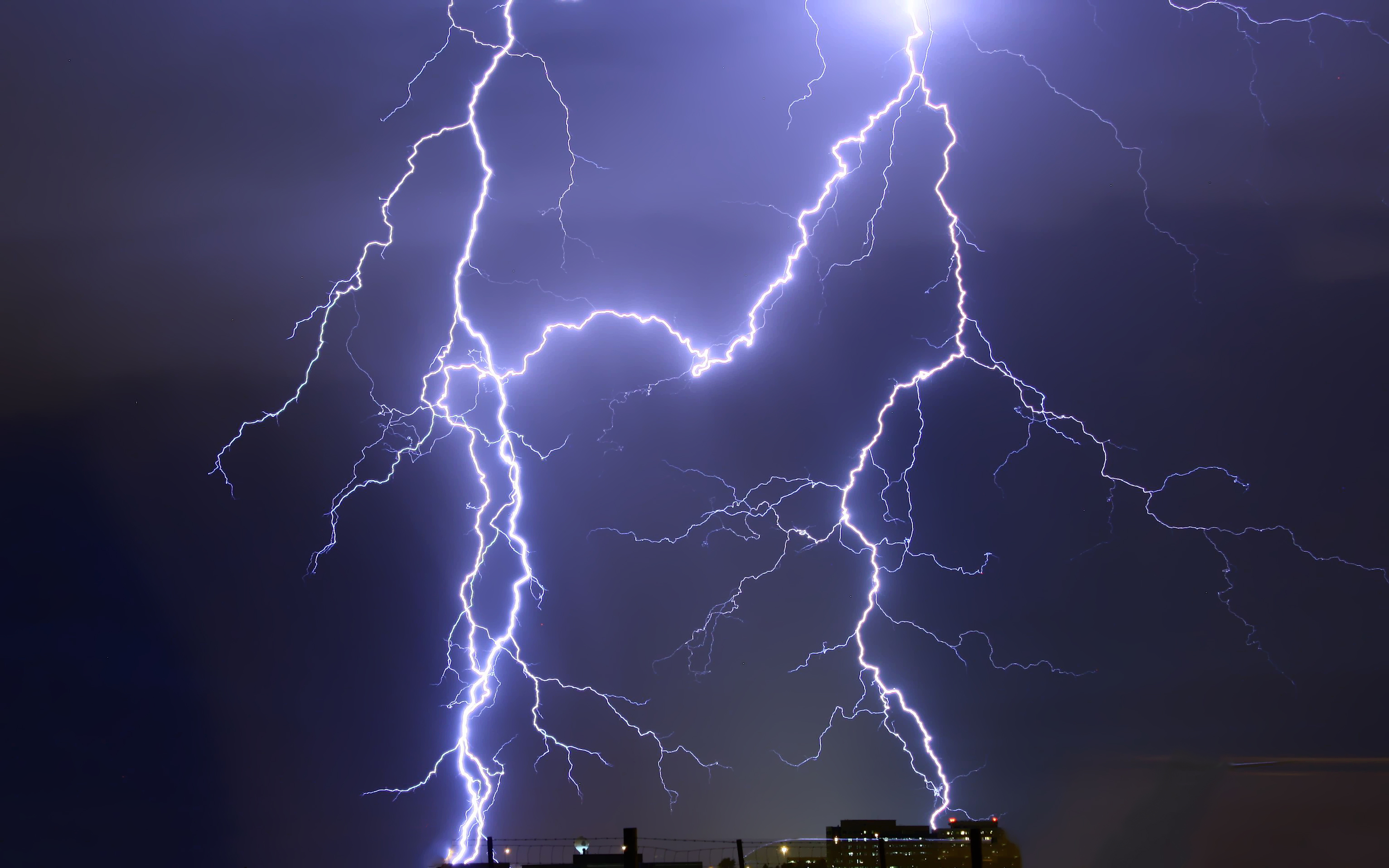 Blue lightning strikes in skyline via GoodFreePhotos.com
